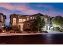 Inviting two-story home with manicured landscaping, gated entrance, and attached two-car garage at 12249 Catanzaro Ave, Las Vegas, NV 89138