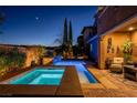 Relaxing pool and spa area with stone accents, and an outdoor seating area at 12249 Catanzaro Ave, Las Vegas, NV 89138