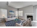 Inviting living room featuring a fireplace, large windows, and comfortable seating at 1660 Cloister Ave, Henderson, NV 89014