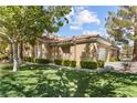 Inviting single-story home featuring a well-manicured lawn, mature trees, and a cozy, neighborhood feel at 2037 Summer Blossom Ct # 101, Las Vegas, NV 89134