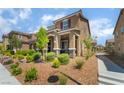 Inviting exterior elevation with desert landscaping, a walkway, and covered front porch at 2422 Fasano St, Henderson, NV 89044