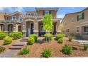 Inviting front yard with desert landscaping, a brick walkway, and covered porch with seating at 2422 Fasano St, Henderson, NV 89044