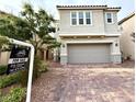 Charming two-story home with a two-car garage and a beautifully paved driveway at 2922 Tranquil Brook Ave, Henderson, NV 89044