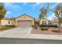 Charming single story home featuring desert landscaping, a tile roof, and an attached two car garage at 2969 Sumter Valley Cir, Henderson, NV 89052