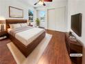 Well-lit bedroom with hardwood floors, a large window, and a spacious closet at 3308 Paragon Dr, Las Vegas, NV 89117
