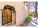 Close-up of a charming front door with security features, desert landscaping, and well-maintained walkway at 4097 Nook Way # A, Las Vegas, NV 89103