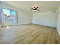 Bright bedroom featuring vinyl floors, a large window, and a ceiling fan at 4324 El Conlon Ave, Las Vegas, NV 89102