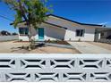 Charming single-story home with a quaint front yard and a bright teal front door at 4324 El Conlon Ave, Las Vegas, NV 89102