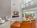 Bright living room with high ceilings, fireplace, large windows, and a view of the green golf course at 5 Clear Crossing Trl, Henderson, NV 89052