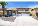 Inviting two-story home with double front doors, two-car garage, and desert rock landscaping at 5 Red Fawn Ct, Henderson, NV 89074