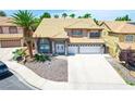 Beautiful two-story house with a large driveway, desert landscaping and tile roofing at 5 Red Fawn Ct, Henderson, NV 89074