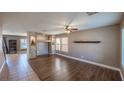 Spacious living room featuring wood floors, a ceiling fan, and built in display shelving at 5031 Naff Ridge Dr, Las Vegas, NV 89131