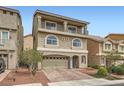 Charming three-story home with a balcony, arched windows, and a brick paved driveway at 5340 Kennedy Hill Ave, Las Vegas, NV 89139