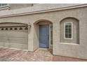 This home's front door is set in an alcove next to a two car garage at 5340 Kennedy Hill Ave, Las Vegas, NV 89139