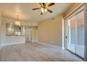 Bright living room featuring modern flooring, ceiling fan and sliding glass door to balcony, offering a serene living space at 55 E Agate Ave # 309, Las Vegas, NV 89123