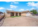 A single story home with a covered front porch, 2-car garage, and low maintenance landscaping at 5530 Berchmans Ave, Las Vegas, NV 89122