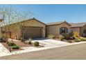 Attractive single-story home with a well-maintained lawn, desert landscaping, and a two-car garage at 5635 E La Campana Dr, Pahrump, NV 89061