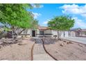 Charming single-story home featuring a three car garage, desert landscaping and a tile roof at 6150 W Brooks Ave, Las Vegas, NV 89108