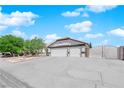 Charming single-story home featuring a three car garage, desert landscaping and a tile roof at 6150 W Brooks Ave, Las Vegas, NV 89108