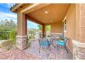 Cozy front porch with brick pillars and an outdoor seating area at 689 Silver Pearl St, Henderson, NV 89002