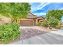 Inviting two-story home with a well-maintained yard and a brick-paved driveway at 689 Silver Pearl St, Henderson, NV 89002
