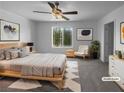 A staged bedroom with neutral walls, carpeted flooring and a large window for natural light at 7452 Sunray Point St, North Las Vegas, NV 89084