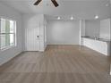 Unstaged living room featuring tiled flooring and bright, neutral walls and open floorplan at 7452 Sunray Point St, North Las Vegas, NV 89084