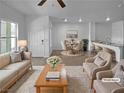 Staged open-concept living area with modern decor, seamlessly blending into a dining area at 7452 Sunray Point St, North Las Vegas, NV 89084