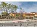 Street view of home with desert landscaping, corner lot and three-car garage at 7568 Shadow Estates Way, Las Vegas, NV 89113