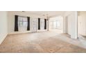 Spacious living room with carpet, large windows, and open layout, ready for personalized design at 7568 Shadow Estates Way, Las Vegas, NV 89113