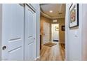 Hallway with wood-look flooring, closet, and views into laundry and bedroom at 8036 Literature Ct, Las Vegas, NV 89113