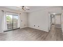 Bright living room features new floors, a ceiling fan, and sliding glass doors to the patio at 8250 N Grand Canyon Dr # 1084, Las Vegas, NV 89166