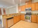 Bright kitchen with stainless steel appliances and a breakfast bar with granite countertops at 8374 Pioneer Way, Las Vegas, NV 89113