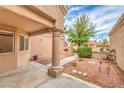 Home courtyard features desert landscaping, covered porch with column, and pathway leading to the entrance at 8513 Glenmount Dr, Las Vegas, NV 89134