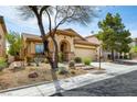 Inviting single-story home featuring desert landscaping and a charming front entrance at 9037 Picket Fence Ave, Las Vegas, NV 89143