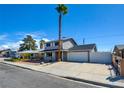 Two-story home with a long driveway and two car garage, complemented by a low maintenance front yard at 125 Sam Jonas Dr, Las Vegas, NV 89145