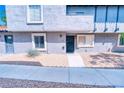 Charming two-story condo features well-maintained landscaping, stucco exterior, and a concrete pathway at 1326 N Jones Blvd, Las Vegas, NV 89108