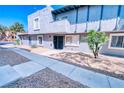 Charming two-story condo with a small tree, well-maintained landscaping and concrete pathway at 1326 N Jones Blvd, Las Vegas, NV 89108