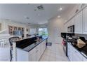 Open-concept kitchen features a large island with bar seating, granite countertops, and modern appliances at 14 Hunt Valley Trl, Henderson, NV 89052