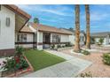Charming front garden with vibrant flowers leads to a cozy single-story home at 1837 Alicant Way, Henderson, NV 89014