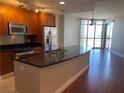 Open kitchen with stainless steel appliances, granite countertops, and a breakfast bar overlooking the living area at 200 W Sahara Ave # 2211, Las Vegas, NV 89102
