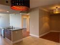 Bright and airy living space with tile flooring and modern pendant lighting, offering a seamless flow to the kitchen at 200 W Sahara Ave # 2211, Las Vegas, NV 89102
