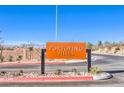 Portofino Hills entrance sign with desert landscaping on a clear day with distant mountains in the background at 208 Biscotti Ave # Lot 124, North Las Vegas, NV 89084