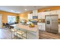 Modern kitchen featuring an island with barstool seating, stainless appliances, and bright white cabinetry at 208 Biscotti Ave # Lot 124, North Las Vegas, NV 89084