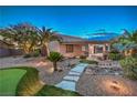 Expansive backyard with synthetic lawn, desert landscaping, and covered patio at 2248 Carrizo Way, Henderson, NV 89052