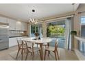 Dining area with modern lighting, sliding glass doors to patio and a view to the pool at 2445 Antler Point Dr, Henderson, NV 89074