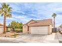 Attractive single-story home with a two-car garage, desert landscaping, and a lush palm tree at 2744 Ironside Dr, Las Vegas, NV 89108