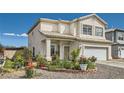 Inviting two-story home boasts of a well-manicured front yard with beautiful plants and a two-car garage at 3332 Beca Faith Dr, North Las Vegas, NV 89032