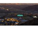 Night aerial view of a luxury home showcasing mountain views in an upscale community at 35 Via Rizzuto, Henderson, NV 89011