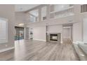 Spacious living room with vaulted ceilings, a fireplace, and sliding glass doors to the backyard at 42 Megan Dr, Henderson, NV 89074